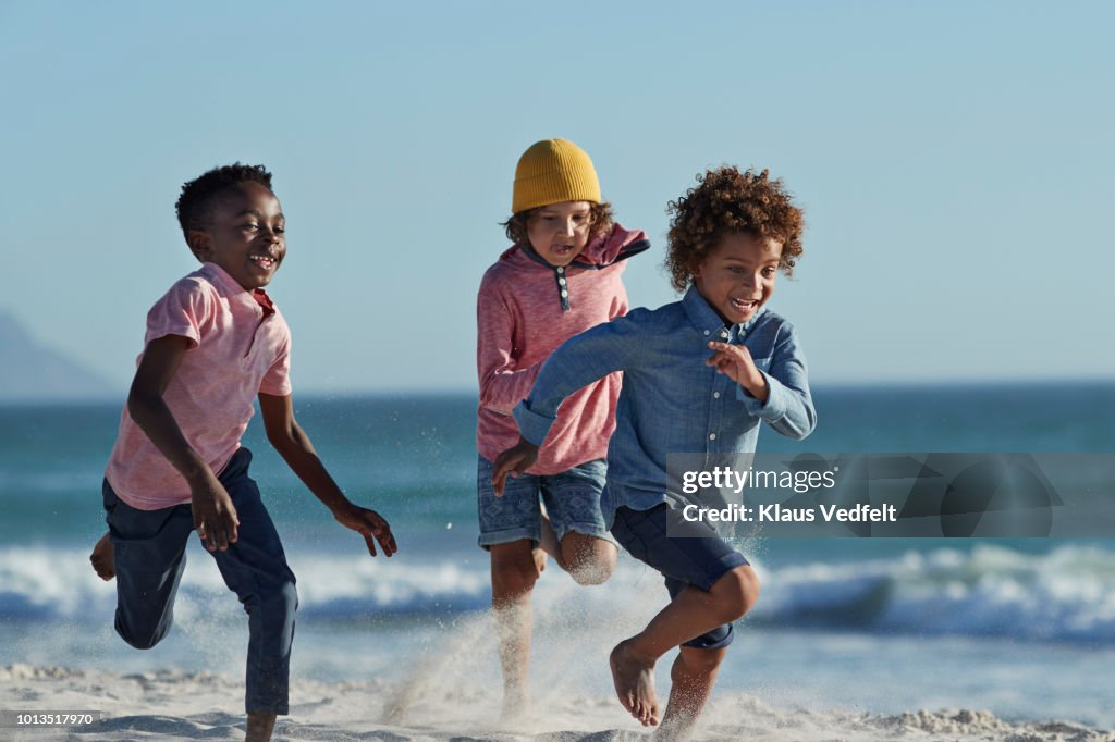 Children running and laughing together on the beach