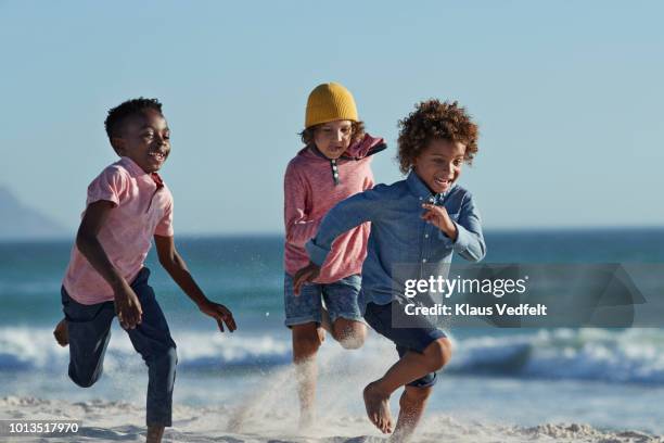 children running and laughing together on the beach - beach running bildbanksfoton och bilder