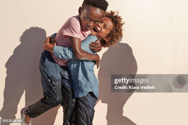 cute boys playing and posing in front of camera - two young boys foto e immagini stock