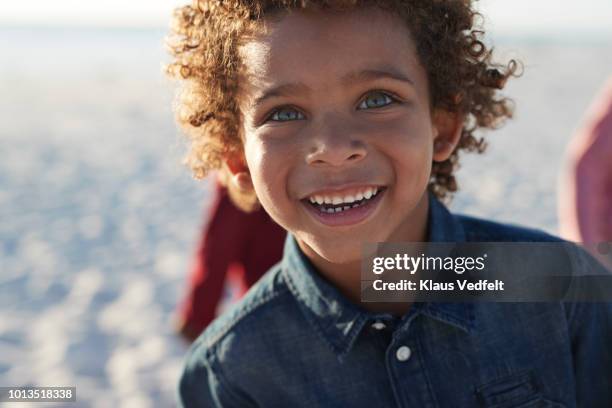 portrait of cute boy enjoying the beach - boy with dark hair blue eyes bildbanksfoton och bilder