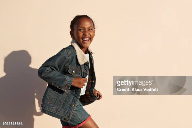 portrait of cute girl laughing, on studio background - three quarter length stock pictures, royalty-free photos & images