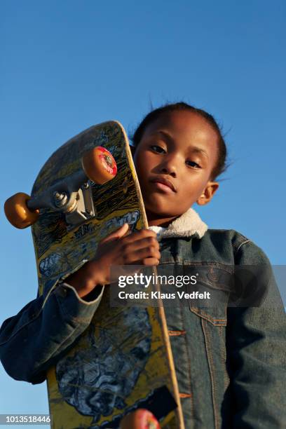 portrait of cool girl holding her skateboard - skateboard foto e immagini stock