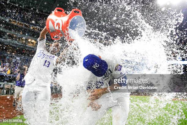 Salvador Perez dumps water onto Heath Fillmyer of the Kansas City Royals after the Royals defeated the Chicago Cubs 9-0 at Kauffman Stadium on August...