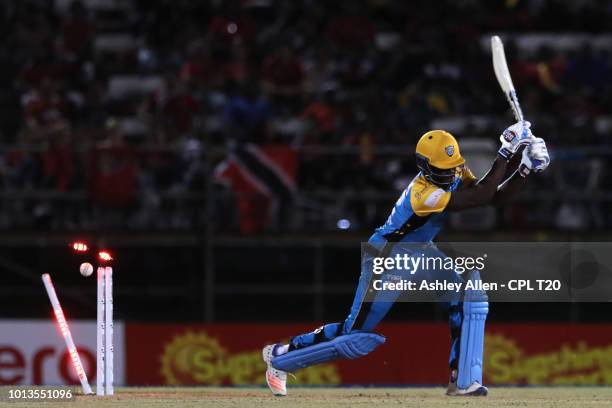 In this handout image provided by CPL T20, Andre Fletcher of St Lucia Stars is bowled by Ali Khan of Trinbago Knight Riders during the Hero Caribbean...