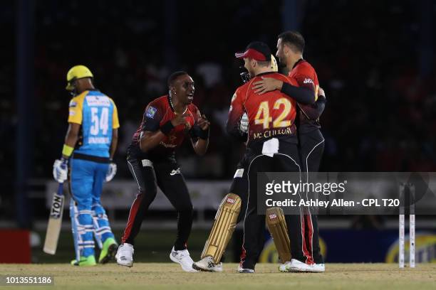 In this handout image provided by CPL T20, Dwayne Bravo of Trinbago Knight Riders celebrates with teammates as Lendl Simmons of St Lucia Stars is...