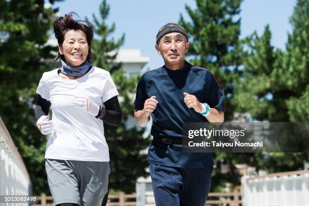 senior generation enjoying jogging with men and women - 運動　日本人 ストックフォトと画像