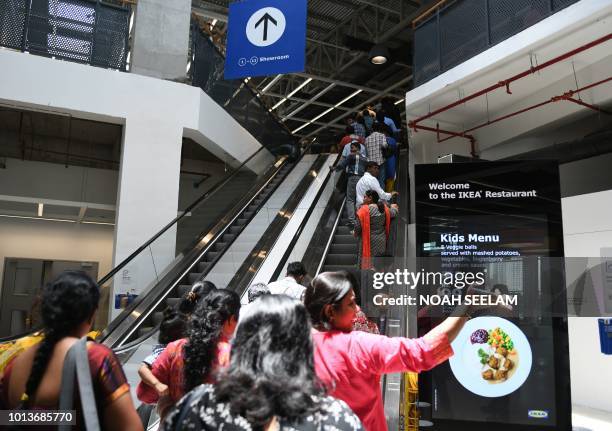 Indian customers enter at the new IKEA store in Hyderabad on August 9, 2018. - Curious customers lay on beds and nestled into armchairs on August 9...