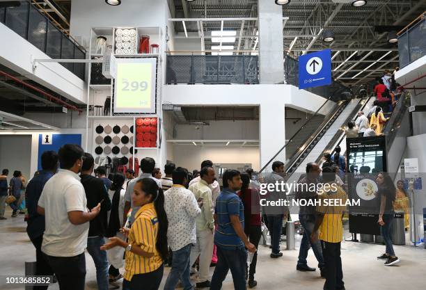 Indian customers enter at the new IKEA store in Hyderabad on August 9, 2018. - Curious customers lay on beds and nestled into armchairs on August 9...