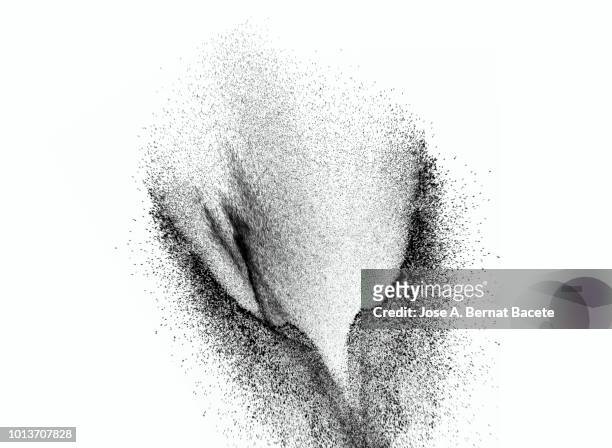 explosion by an impact of a cloud of particles of powder of color gray and black on a white background. - black powder stock-fotos und bilder
