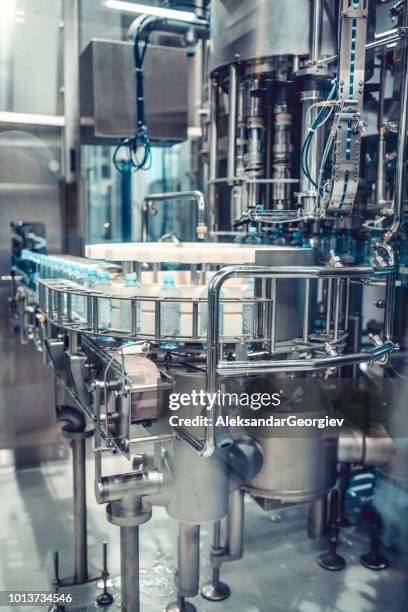 machinery used to bottle water in plant - fog machine stock pictures, royalty-free photos & images