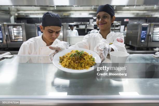 An employee serves a plate of biryani rice at the restaurant inside the Ikea store in Hitech City on the outskirts of Hyderabad, India, on Thursday,...