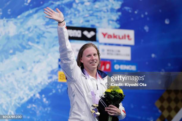 Gold medalist Lillia King of the United States celebrates on the podium at the medal ceremony for the Women's 100m Breaststroke on day one of the Pan...