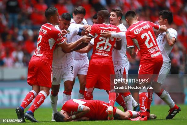 Players of Toluca and Chivas fight during the third round match between Toluca and Chivas as part of the Torneo Apertura 2018 Liga MX at Nemesio Diez...