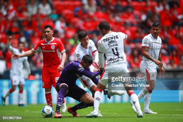 Alfredo Talavera of Toluca struggles for the ball with Jair Pereira of Chivas during the third round match between Toluca and Chivas as part of the...