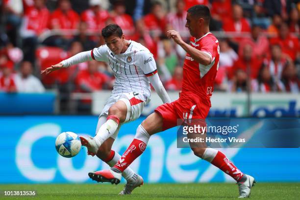 Angel Zaldivar of Chivas struggles for the ball with Osvaldo Gonzalez of Toluca during the third round match between Toluca and Chivas as part of the...