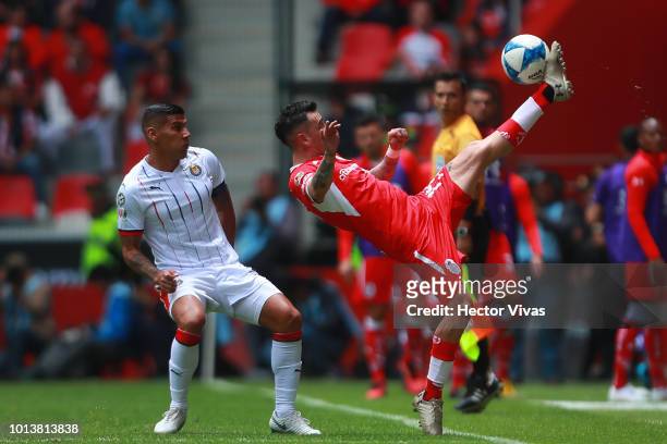 Carlos Salcido of Chivas struggles for the ball with Rubens Sambueza of Toluca during the third round match between Toluca and Chivas as part of the...