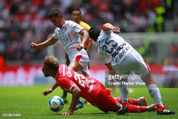 Pedro Canelo of Toluca struggles for the ball with Michael Perez of Chivas during the third round match between Toluca and Chivas as part of the...