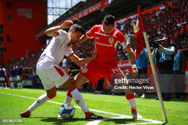 Rubens Sambueza of Toluca struggles for the ball with Josecarlos Van Rankin of Chivas during the third round match between Toluca and Chivas as part...