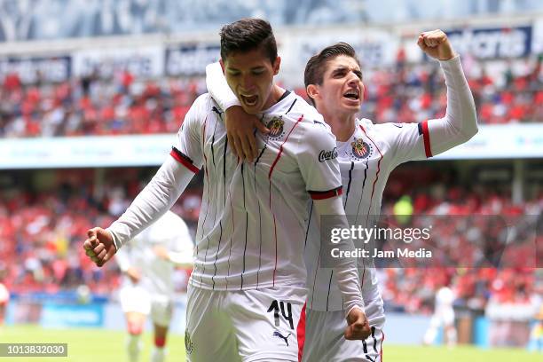 Angel Zaldivar of Chivas celebrates with teammate Isaac Brizuela after scoring his first goal during the third round match between Toluca and Chivas...
