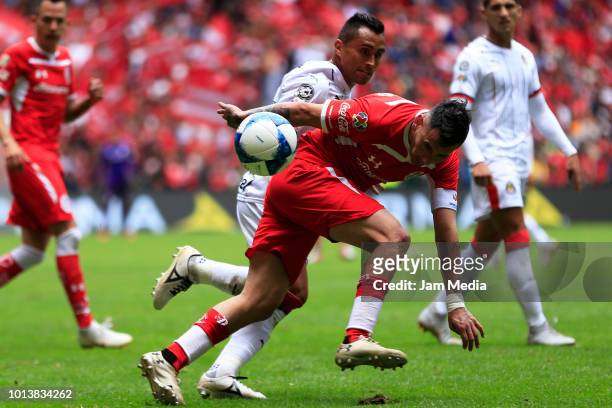 Rubens Sambueza of Toluca and Edwin Hernandez of Chivas fight for the ball during the third round match between Toluca and Chivas as part of the...