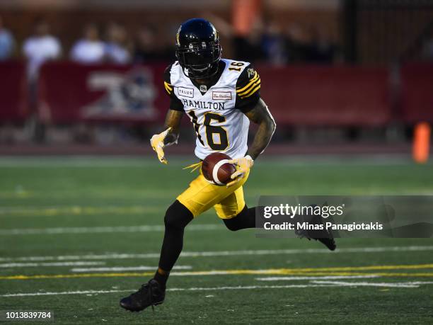 Wide receiver Brandon Banks of the Hamilton Tiger-Cats runs with the ball against the Montreal Alouettes during the CFL game at Percival Molson...