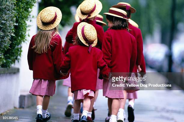 a group of schoolgirls, walking - school uniform stock pictures, royalty-free photos & images