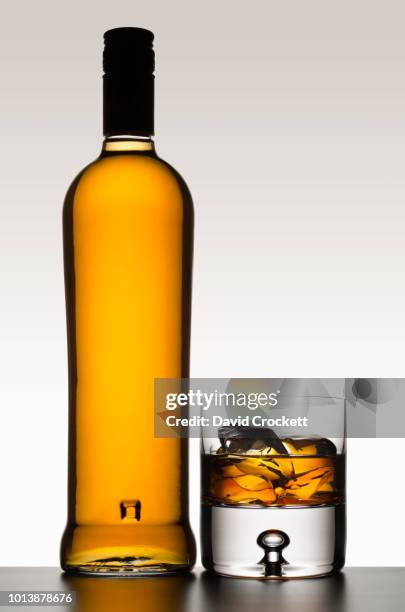 whisky bottle with glass - brown bottle stock pictures, royalty-free photos & images