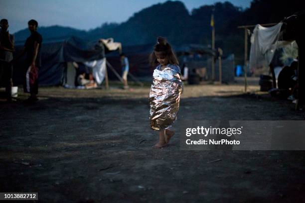 Child wears space blanket in Refugee camp in Velika Kladusa, BiH on August 7, 2018.