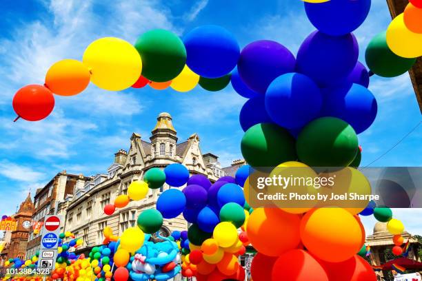 rainbow balloons of the pride parade in brighton uk - light festival parade stock pictures, royalty-free photos & images