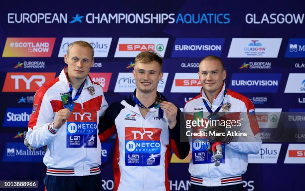 Silver medalist Ilia Zakharov of Russia, Gold medalist Jack Laugher of Great Britain and Bronze medalist Evgenii Kuznetsov of Russia pose with their...