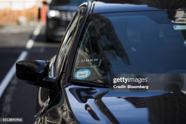 The Uber Technologies Inc. Logo is seen on the windshield of a vehicle in New York, U.S., on Thursday, Aug. 9, 2018. New York's city council dealt a...