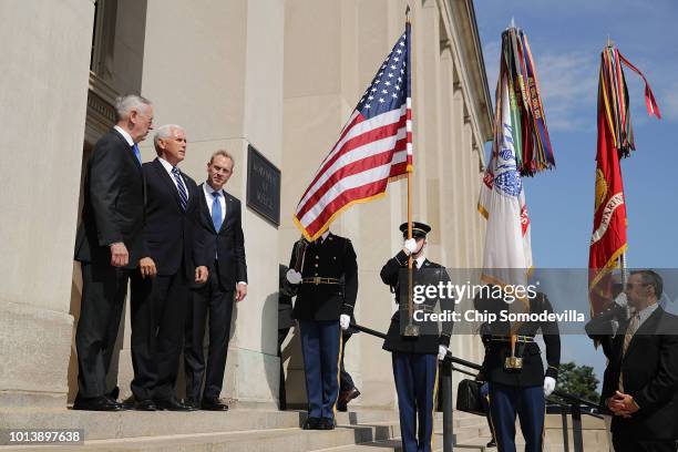 Defense Secretary James Mattis, Vice President Mike Pence and Deputy Secretary of Defense Patrick Shanahan pause before entering the Pentagon August...