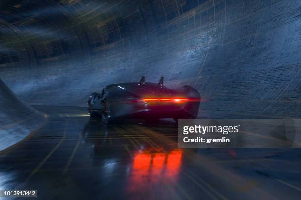 generische futuristischen sportwagen beschleunigt in die unterirdischen tunnel - rear light car stock-fotos und bilder
