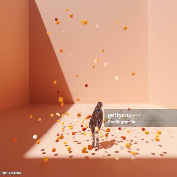 surreal bent astronaut in cubic room with falling spheres - balls bouncing stock pictures, royalty-free photos & images