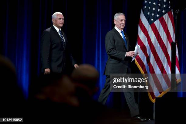 Jim Mattis, U.S. Secretary of defense, right, and U.S. Vice President Mike Pence arrive to speak at an event at the Pentagon in Washington, D.C.,...