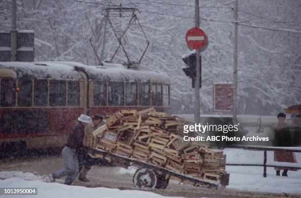Sarajevo, Bosnia-Herzegovina Men moving wagon through street, the 1984 Winter Olympics / XIV Olympic Winter Games.