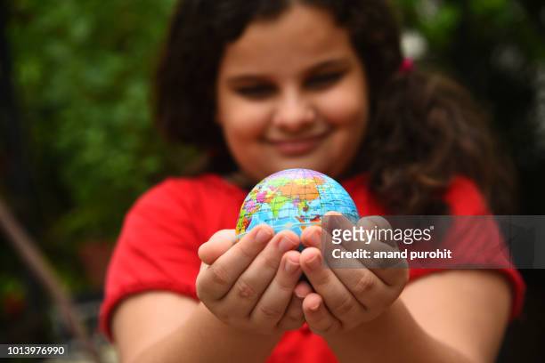 hands protecting globe or earth - world environment day - world environment day poster stock-fotos und bilder