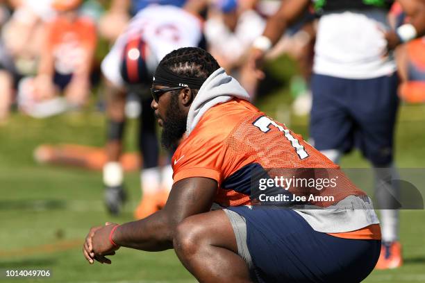 Offensive tackle Menelik Watson watching warmups during Denver Broncos training camp at the UCHealth Training Center August 9, 2018 in Englewood,...