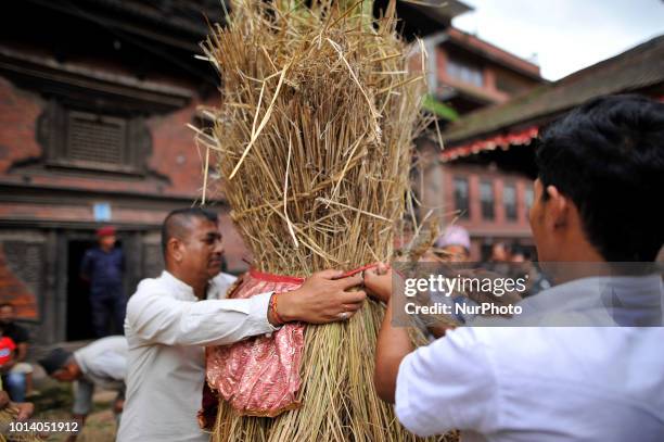 Nepalese devotees making straw effigy demon Ghantakarna during the Gathemangal festival celebrated at Thimi, Bhaktapur, Nepal on Thursday, August 09,...