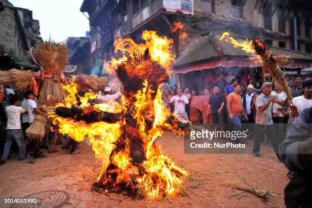 Nepalese devotees celebrate by burning effigy of demon Ghantakarna during the Ghantakarna or Gathemangal festival celebrated at Bhaktapur, Nepal on...