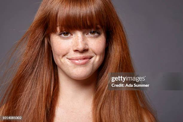 smiling woman with windblown red long hair - thick white women stock pictures, royalty-free photos & images