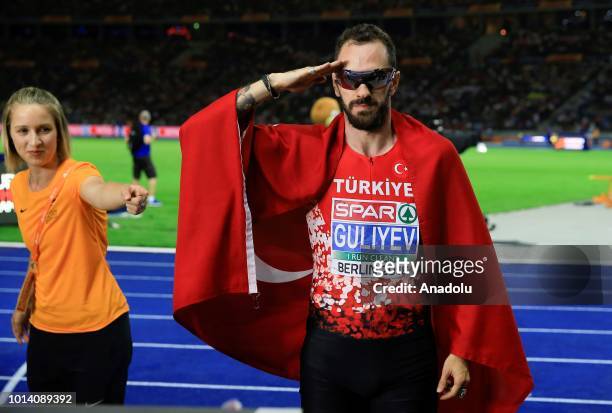 Turkish athlete Ramil Guliyev celebrates after winning the gold medal with 19.76 seconds in 200-meter men's race final during the fourth day of the...