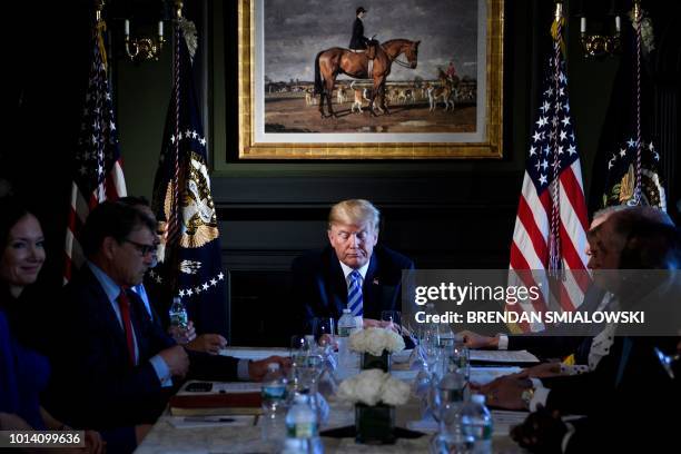 President Donald Trump waits for a meeting with administration and state officials on prison reform at the Trump National Golf Club August 9, 2018 in...