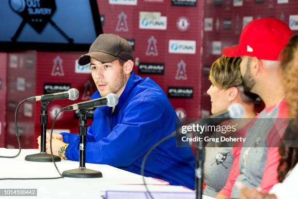 Singer-Songwriter Nick Jonas, Deidre Pujols and Albert Pujols attend the Strike Out Slavery Press Conference at Angel Stadium on August 9, 2018 in...