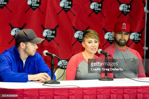 Singer-Songwriter Nick Jonas, Deidre Pujols and Albert Pujols attend the Strike Out Slavery Press Conference at Angel Stadium on August 9, 2018 in...