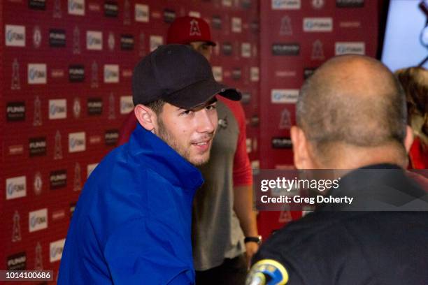 Singer-Songwriter Nick Jonas and Angels First Baseman Albert Pujols meet the Anaheim Police Chief as he attends the Strike Out Slavery Press...