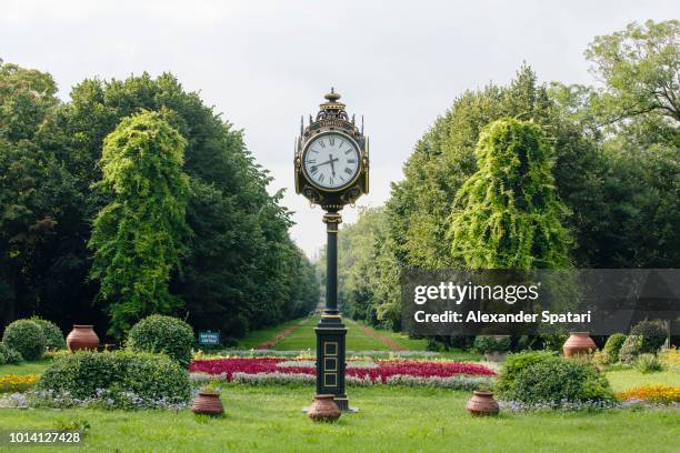 antique clock on the park alley in cismigiu park, bucharest, romania - bucarest photos et images de collection