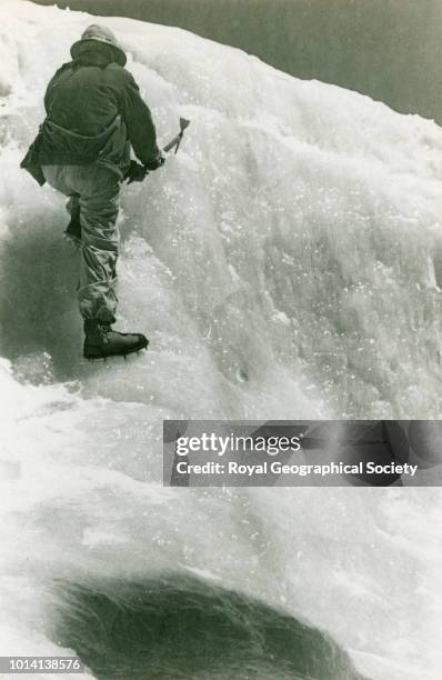 Climber ice climbing wearing crampons on the Aconcagua glacier, Argentina, 1934.