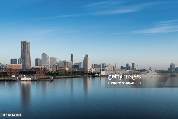 view of city at waterfront against cloudy sky - kanagawa prefecture stock pictures, royalty-free photos & images