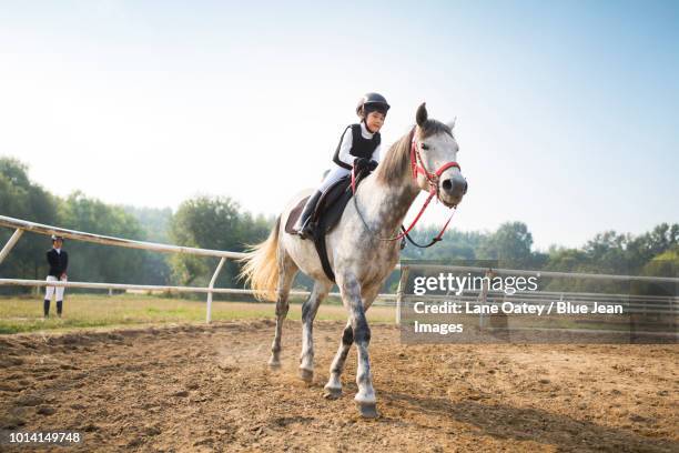 cheerful little boy riding horse - horse front view stock pictures, royalty-free photos & images